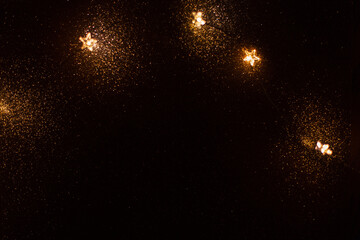 Magic gold background with stars lights bokeh. Festive Christmas background. New Year golden...