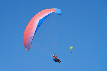 Paraglider under red dome against blue sky. Copy space.