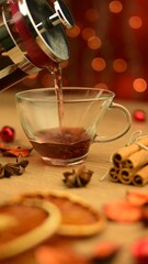 steaming cup of tea with cozy setting and bokeh background at christmas