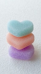 Obraz premium Colorful heart-shaped candies stacked for a cheerful Valentine's Day celebration in a studio setting