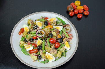 Salad Nicoise -Tuna, with green beans, cherry tomatoes, eggs, cooked potatoes, black olives, anchovies, and a vinaigrette mustard dressing