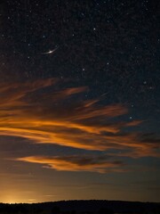 Naklejka premium Jupiter and Saturn visible in the night sky with moving orange clouds.