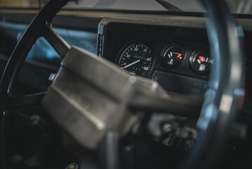 Interior of a old, classic 4x4 luxury truck in a garage.