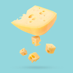Piece of fresh cheese falling on light blue background
