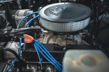 Restored v8 engine of a classic car under the bonnet.