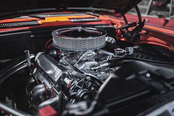 Restored v8 engine of a classic car under the bonnet.