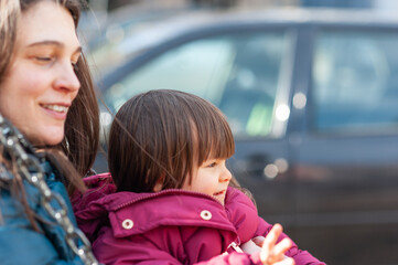 A portrait of a little girl on a swing with her aunt