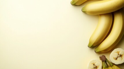 A corner of a pale yellow background with a few fresh bananas, arranged to show their smooth texture and potassium content, leaving blank space for text.