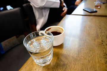 Close-up shots of a doctor chatting and drinking coffee and water during lunch break