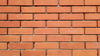 Obraz premium brick wall texture with a vibrant red and brown color pattern. Perfect for architectural backgrounds and designs, offering a rustic and classic aesthetic.
