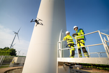 A group of workers in high-visibility gear joyfully high-fives each other after completing their...