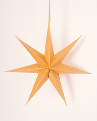 Brown paper three-dimensional Christmas stars, each 30 cm in diameter, crafted with precision to...