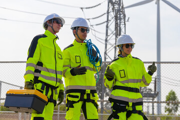 A group of workers in high-visibility gear joyfully high-fives each other after completing their...