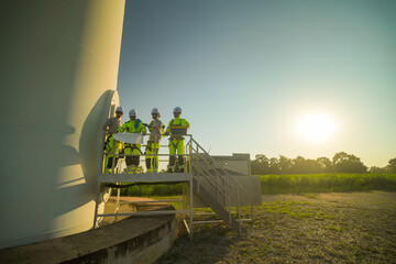 A group of  workers in high-visibility gear joyfully high-fives each other after completing their...