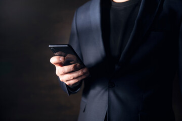 Business man hand holding smart phone