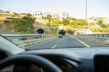 Driver view to the road with tunnel. Madeira island, Portugal.