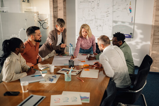 Marketing professionals collaborating on project in modern office
