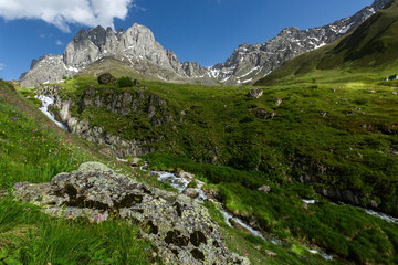 Hiking trail to Chaukhi mount from the village of Juta. Beautiful waterfall under Chaukhi. Chaukhistskhali river. Breathtaking landscape.