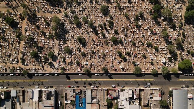 horizontal drone video of cars driving at the motor road in Durango Mexica near city cemetery