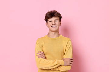 Fototapeta premium Portrait of happy teenage boy on pink background
