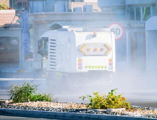 Abu Dhabi, Arab Emirates. Sweeping car on a city street. Road dust