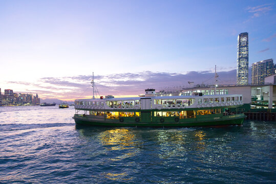 Star Ferry sailing on Victoria Harbour during a spectacular sunset with the skyline in the background. Hong Kong - 25th October 2024