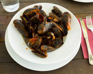 Delicious seafood mussels with tomato sauce on plate