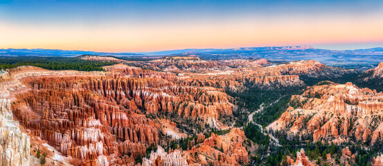 Bryce Canyon National Park panorama in Utah viewed from Bryce point at dusk. Bryce Canyon is a collection of giant natural amphitheaters along the eastern side of the Paunsaugunt Plateau