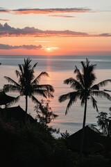 Fototapeta premium Sunset ocean view; tropical palms, silhouettes, structures.