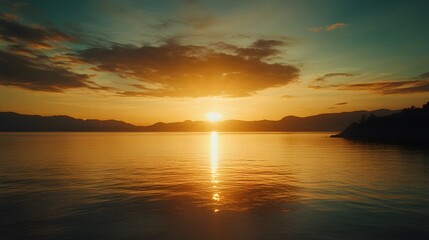 Fototapeta premium Vibrant sunset over calm lake and mountains.
