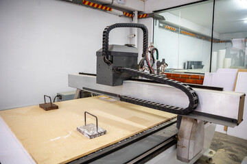 Operator working on a plasma cuaPlasma cutting machine for different substrates such as MDF board, trupan, foam, wood, etc.tting machine for different substrates such as MDF board.