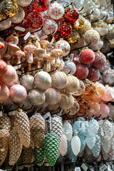 Christmas tree ornaments on the shelves in a decor store close-up
