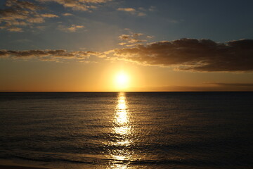 sunset over the ocean blue sky at evening