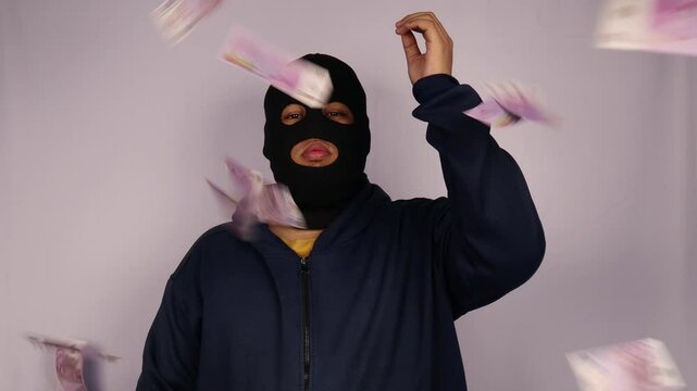 close up on the thief throwing away his bundles of 500 euro banknotes and wearing a jacket with a white background.
