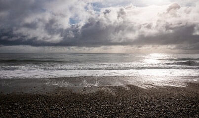 Picturesque beach with small waves sea foam new zealand west coast