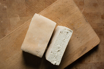 Overhead view of hardtack bread on a wood chopping board, top view of nigerian hardtack also known as kpo kpo madiga