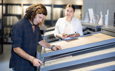 Nice couple in hardware store looking to buy bathroom tiles