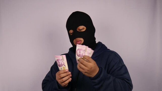close up on the thief wearing jacket counting bundles of ten thousand Singapore dollar banknotes with white background.
