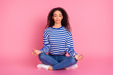 Full size photo of pretty young girl sit floor meditate isolated on pink color background