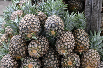 Ripe pineapple stacked and ready for sale at a fruit stand in the Philippines in a horizontal format_20241020_DSC_1531.