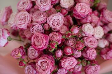A close-up of a vibrant bouquet of pink roses, showcasing their delicate petals and natural beauty. Perfect for themes of love, romance, celebrations, or floral arrangements.