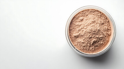 A protein powder in a small clear container, solid white background, top view