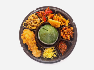 Cone shaped rice or Tumpeng mini covered with banana leave with fried chicken and other side dish, served as festive and traditional dish of Indonesia in any ocassion. 