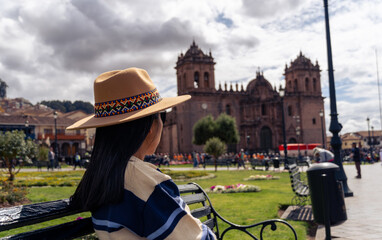 Young tourist resting in the Plaza de Armas in Cusco.
