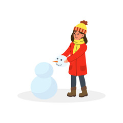 Child building a snowman in winter attire during a snowy day