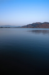 Naklejka premium Ripples on the natural lake of the Dalyan river. On the delta of the river just before dusk 