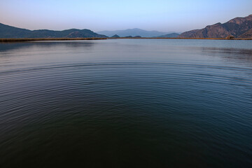 Ripples on the natural lake of the Dalyan river. On the delta of the river just before dusk 