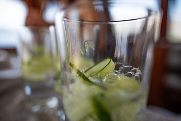 Mojito preparation using cucumber and lime.