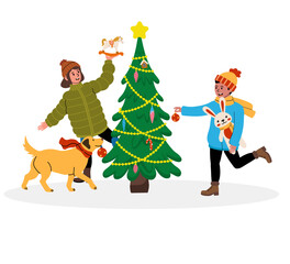 Children decorating a Christmas tree with their dog in winter festive clothing