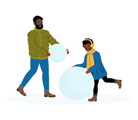 Family enjoys winter fun while building snowballs together outdoors